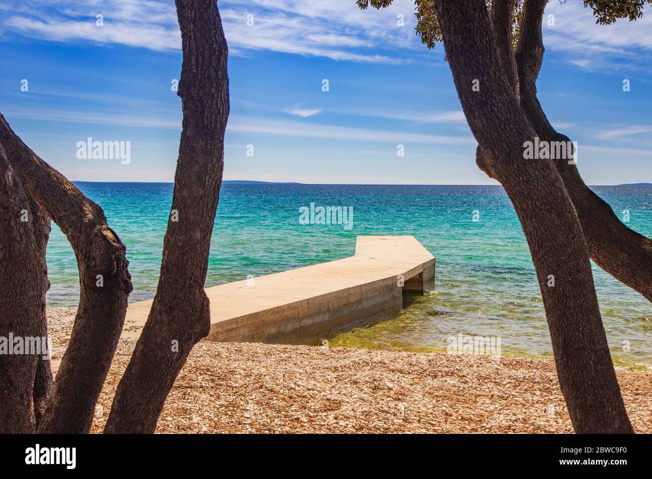 Croatie, île de Pag, belle plage sous les pins, eaux turquoise de la mer Adriatique le jour ensoleillé d'été. Destination touristique célèbre. Banque D'Images