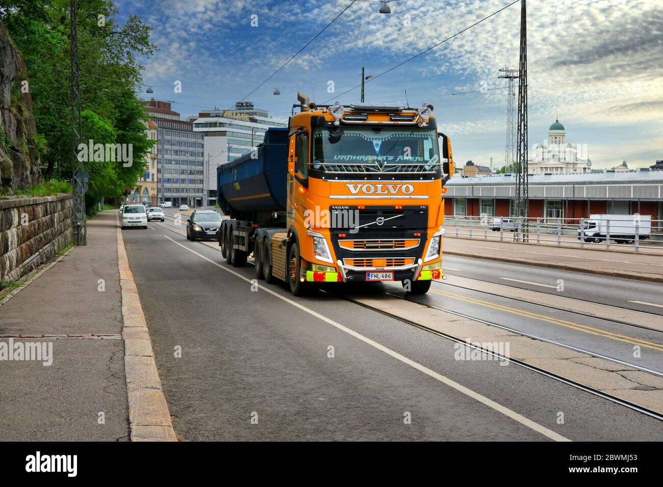 Camion de benne Volvo FH personnalisé jaune de Suomen Vuokraurakointi Oy conduite le long de la rue, paysage de ville arrière-plan. Helsinki, Finlande. 1er juin 2020. Banque D'Images