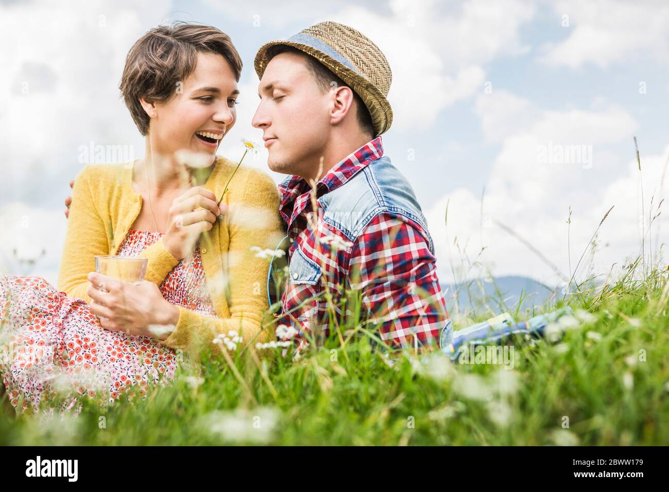 Couple pique-nique sur un pré dans les montagnes, Achenkirch, Autriche Banque D'Images