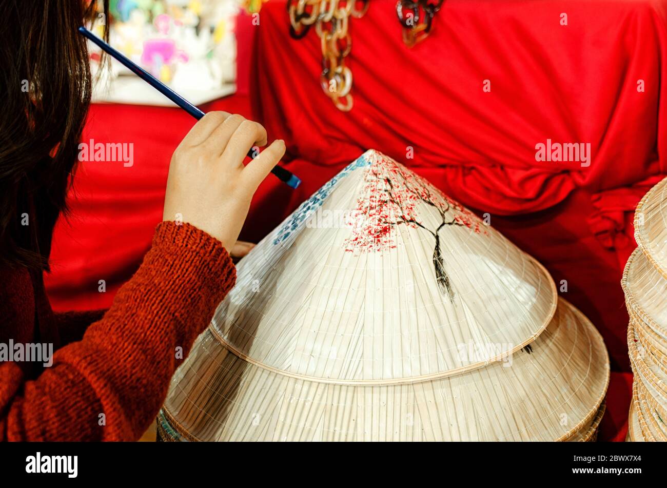 femme peint à la main un chapeau chinois traditionnel avec fond rouge Banque D'Images