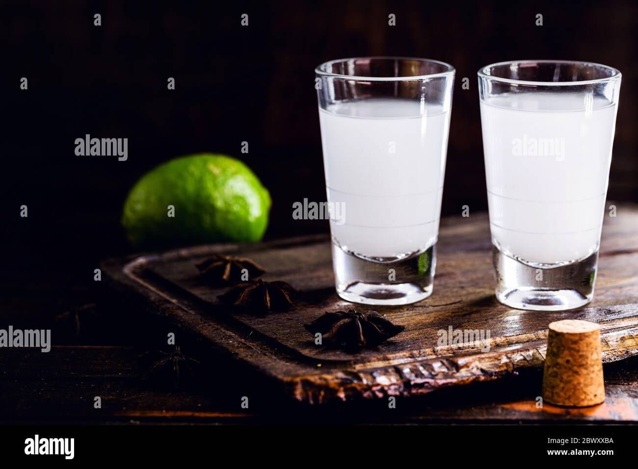 Ouzo ou Uzo, est un brandy grec anis, boisson alcoolisée traditionnelle forte dans des verres sur l'ancienne table en bois. Tradition grecque, boisson des dieux. Placer Banque D'Images