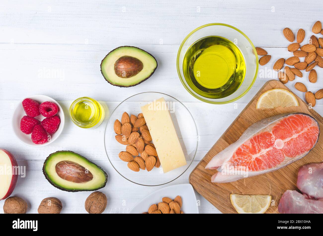 Keto alimentation, bas carb nourriture saine. Avocat, poisson, huile, noix sur fond blanc Banque D'Images