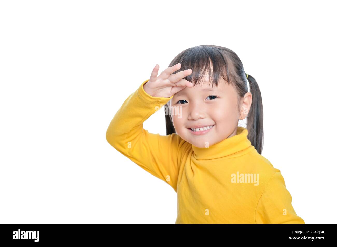 Petite fille asiatique sourire regardant loin sur fond blanc avec espace de copie Banque D'Images