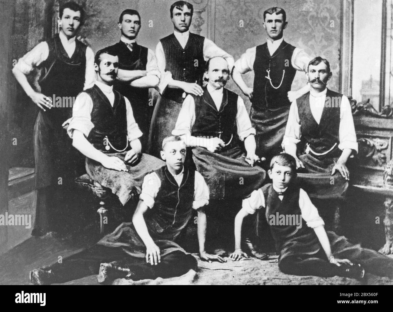 Photo de groupe de l'atelier du maître tinsmith Anton Porsche à Maffersdorf rechts der Neisse. A droite et à gauche du propriétaire (au centre) sont les deux compagnons principaux, derrière lui sont les compagnons et devant les deux apprentis, en dessous (à droite) le 14 créateur de la Volkswagen, qui est devenu plus tard le professeur Dr. Ing. H. c.. Porsche Ferdinand. Banque D'Images