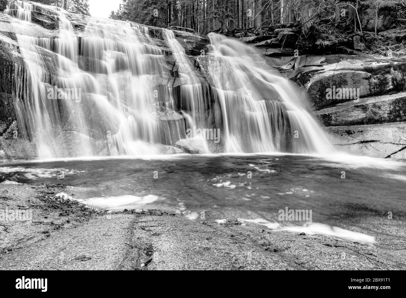 Cascade de Mumlava en automne, Harrachov, montagnes géantes, parc national de Krkonose, République tchèque. Image en noir et blanc. Banque D'Images