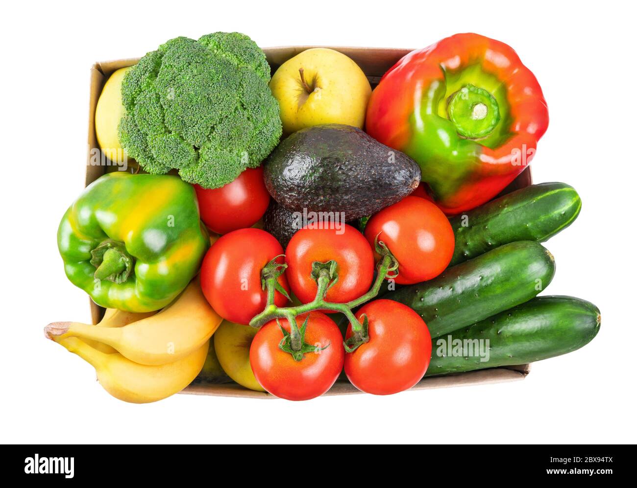 Différents légumes, fruits dans une boîte en carton sur blanc, vue du dessus. Banque D'Images