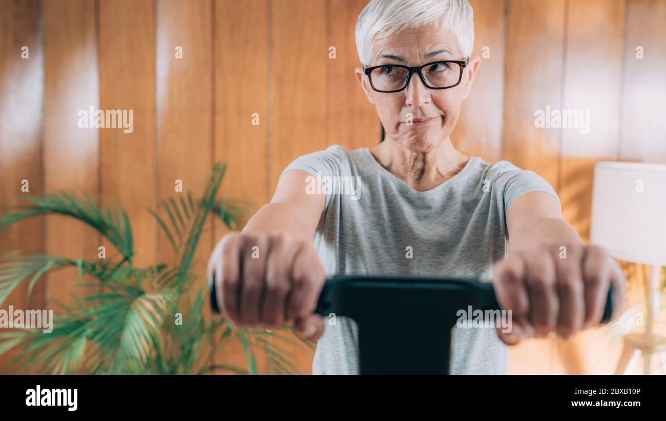 Femme âgée mesurant la composition corporelle avec échelle numérique Banque D'Images