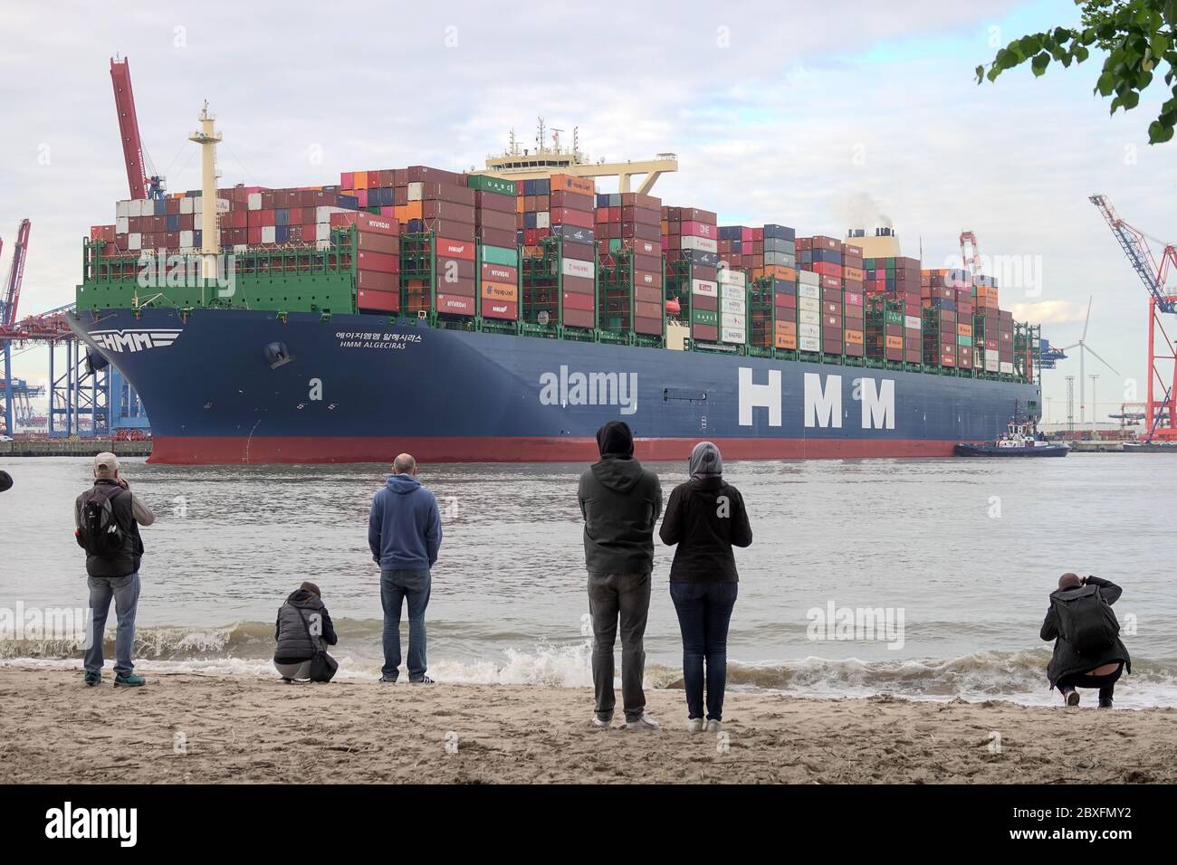 Hambourg, Allemagne. 07e juin 2020. Les spectateurs regardent le plus grand navire à conteneurs du monde, HMM Algeciras, entrer dans le port de Hambourg lors de son premier voyage. Crédit : Bodo Marks/dpa/Alay Live News Banque D'Images