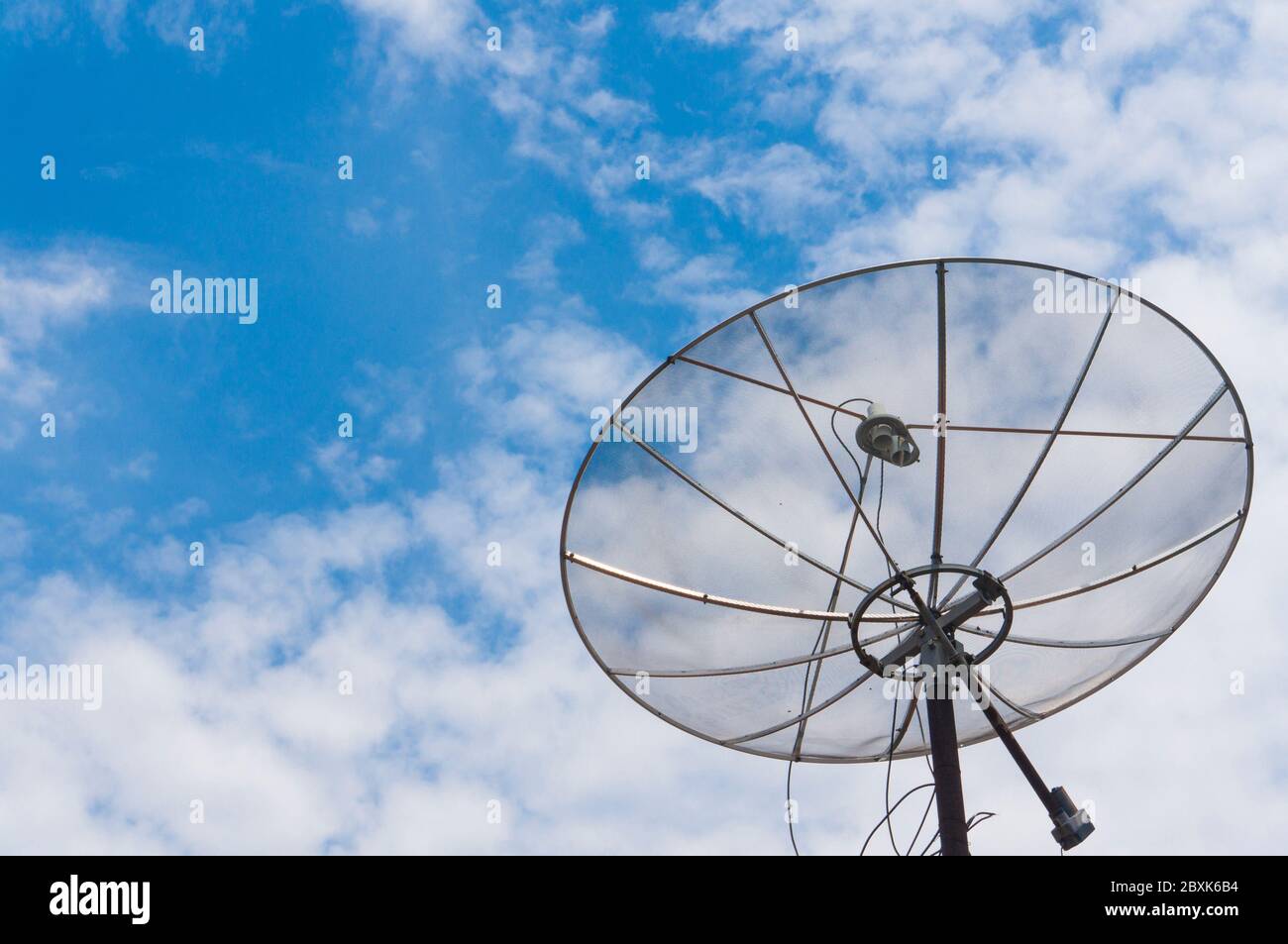 Antenne parabolique avec fond bleu ciel. Une des technologies de diffusion de la télévision dans tous les coins du monde Banque D'Images