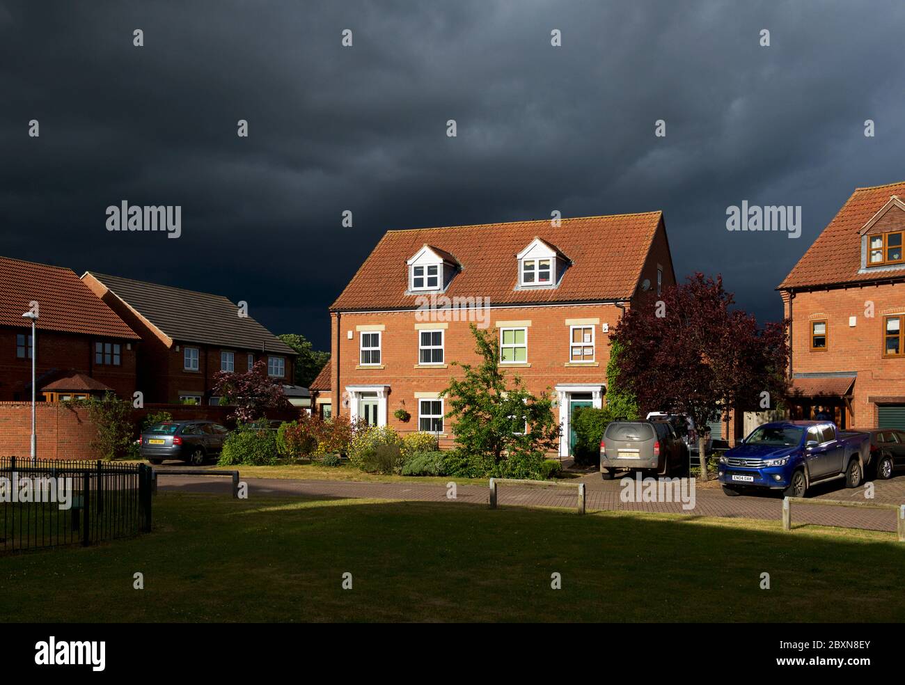 Maison sous le ciel orageux dans le village de Bubwith, East Yorkshire, Angleterre Banque D'Images