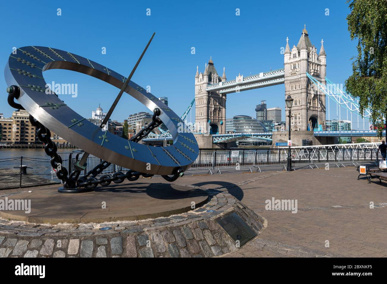 La sculpture du soleil du Timepiece sur la rive nord de la Tamise avec vue sur Tower Bridge en arrière-plan. Banque D'Images