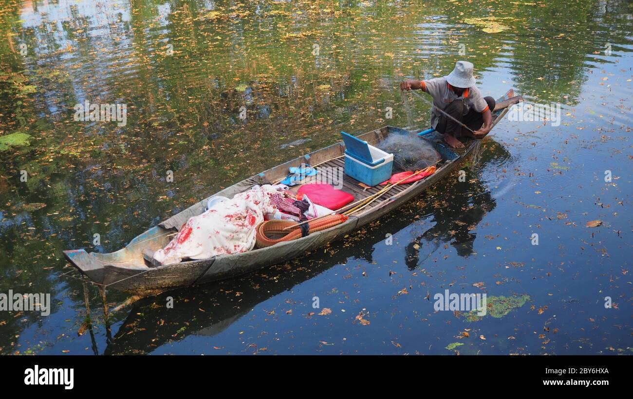 cambodge siem reap river man dans la pêche en bateau avec le filet de fonte Banque D'Images