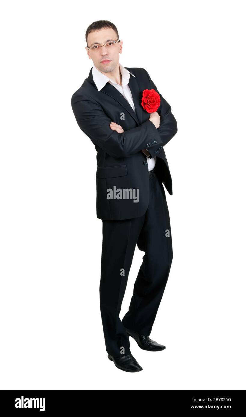 Un homme avec un danseur de tango dans une fleur de tissu rouge dans sa poche de veste Banque D'Images