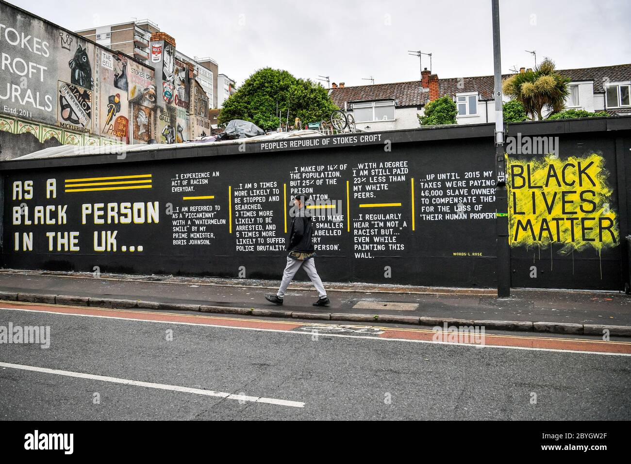 Un homme passe devant un graffiti sur la matière de Black Lives sur un mur dans le quartier de Stokes Croft à Bristol à la suite d'une série de manifestations Black Lives Matter ont eu lieu dans tout le Royaume-Uni pendant le week-end. Les manifestations ont été déclenchées par la mort de George Floyd, qui a été tué le 25 mai alors qu'il était en garde à vue dans la ville américaine de Minneapolis. Banque D'Images