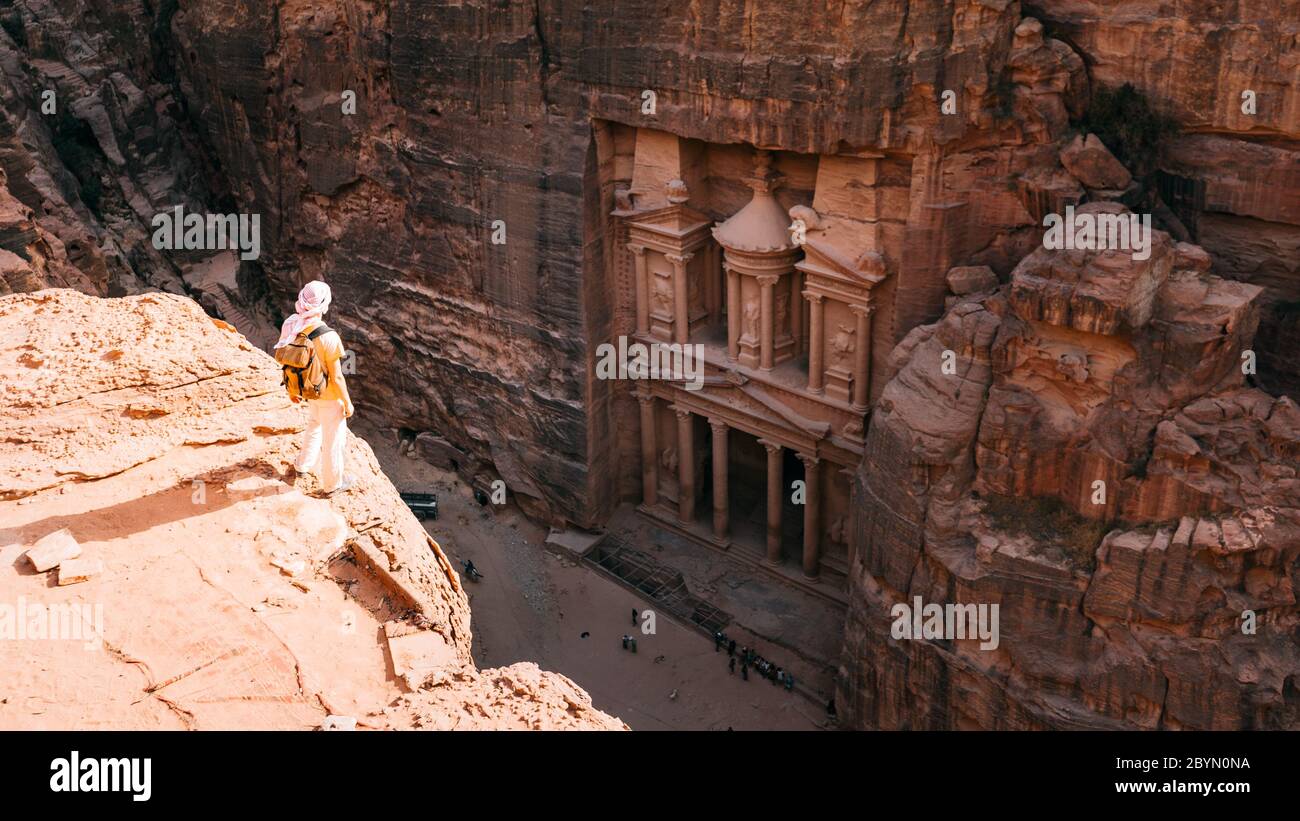 Le randonneur a atteint le sommet de la montagne et a regardé le coucher du soleil. Belle vue sur le paysage Al Khazneh - le trésor, ancienne ville de Pétra, Jordanie Banque D'Images