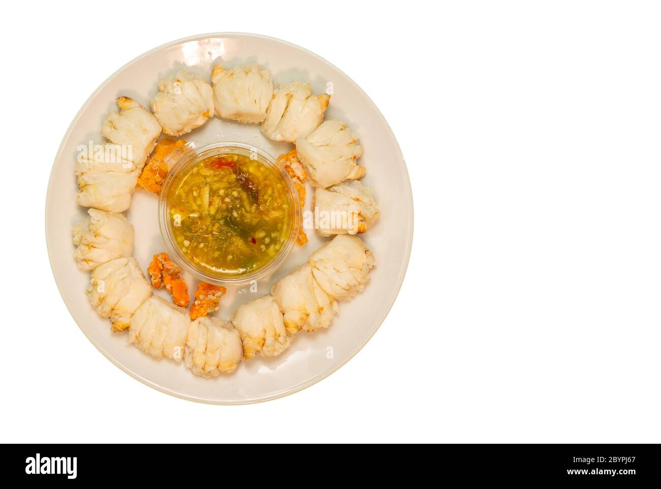 Crabe chaud frais sélectionnez une griffe de crabe sur une assiette avec sauce aux fruits de mer prête à servir sur fond blanc. Banque D'Images