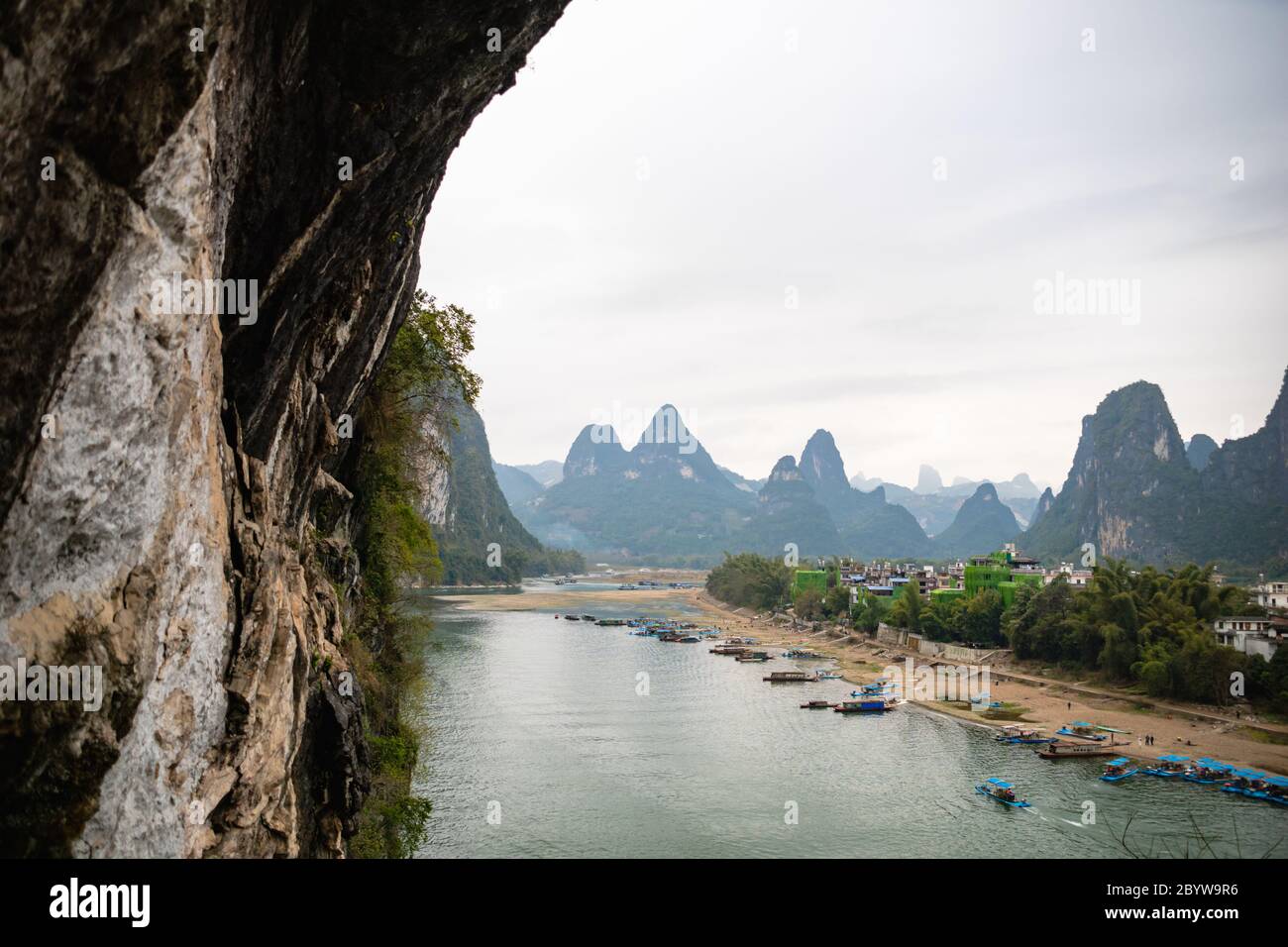 La vue sur le fleuve Li et les montagnes karstiques / collines et bateaux de croisière à Yangshuo, Guangxi, Chine, l'une des destinations touristiques les plus populaires de Chine. Banque D'Images