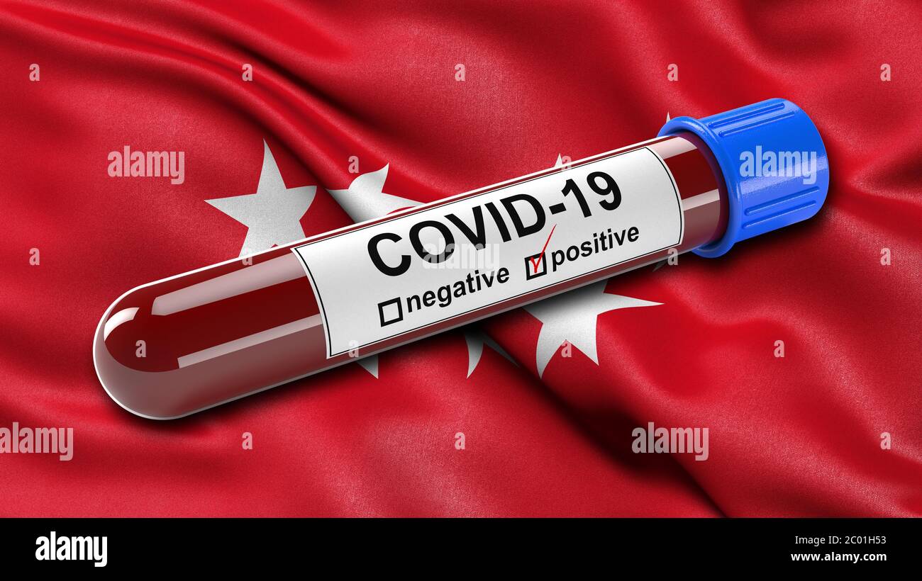 Drapeau de la Communauté de Madrid agitant dans le vent avec un tube à essai sanguin Covid-19 positif. Banque D'Images