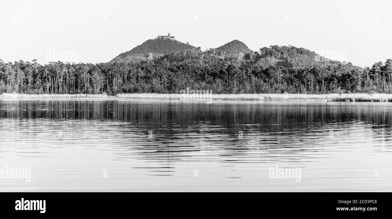 Château médiéval de Bezdez au sommet de la montagne de Bezdez. Se reflète à Brehynsky Pond, République tchèque. Image en noir et blanc. Banque D'Images