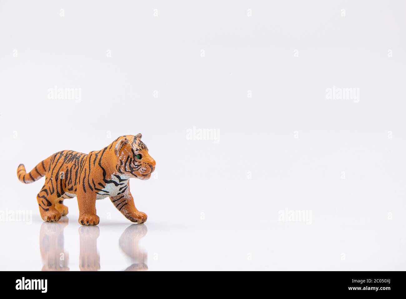 gros plan d'un bébé tigre d'un jouet en plastique isolé sur fond blanc Banque D'Images