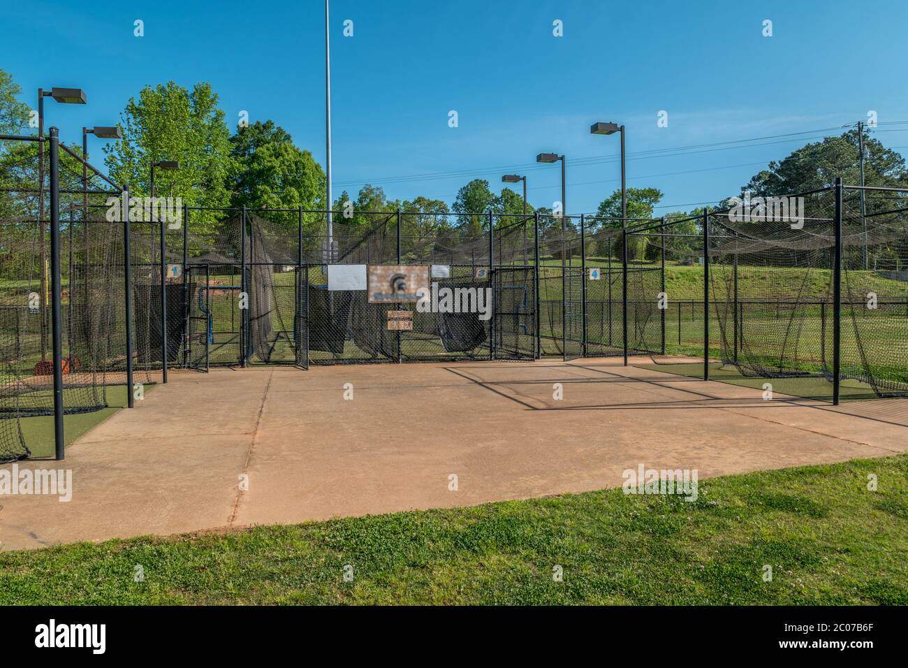 Des cages de base-ball vides et vides dans un terrain de softball de baseball dans un parc fermé en raison de la pandémie Covid-19 au début du printemps Banque D'Images