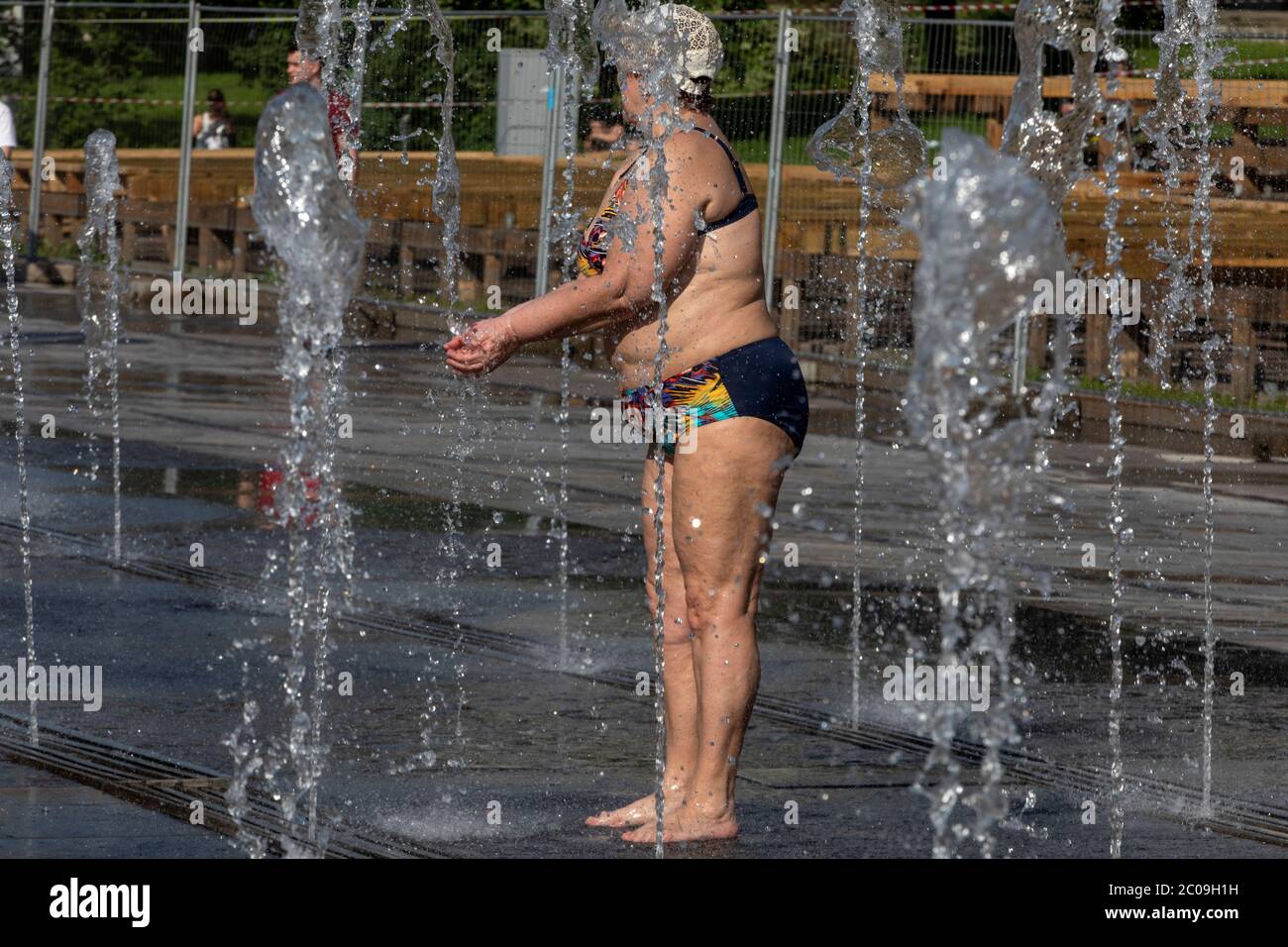 Moscou, Russie. 11 juin 2020 une vieille femme se baigne dans une fontaine  du parc Muzeon sur le remblai de Krymskaya pendant le temps chaud anormal à  Moscou, en Russie. Le 11