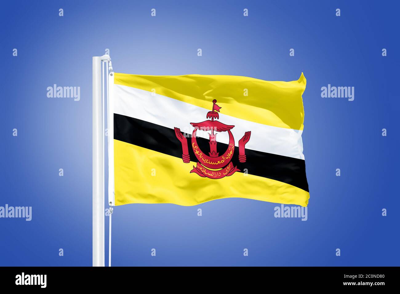 Drapeau du Brunei volant contre un ciel bleu Banque D'Images