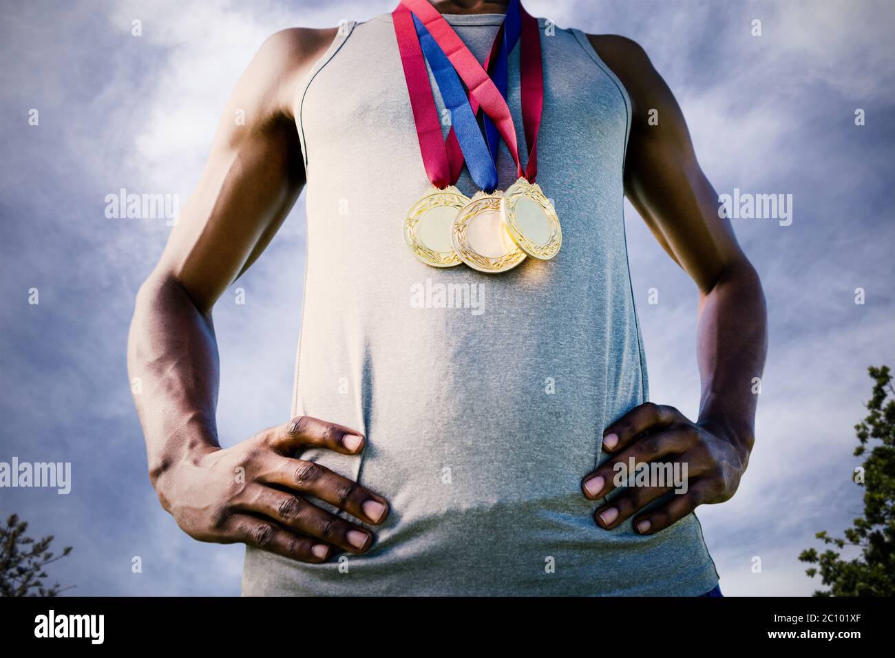 Image composite de low angle view of sportsman poitrine avec des médailles Banque D'Images