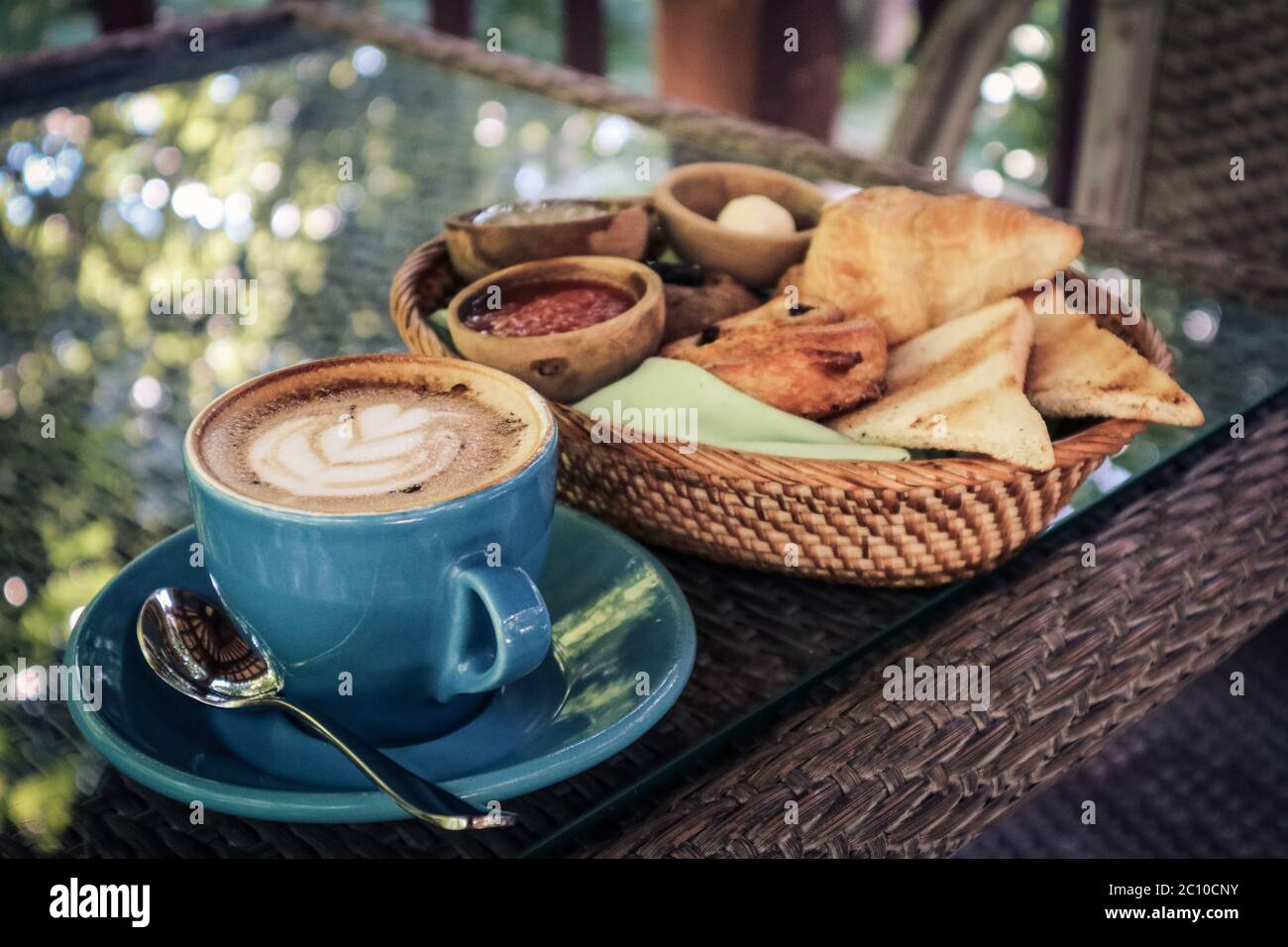 Café-Latte avec croissant et panier à pain sur la table dans le café de la ferme Banque D'Images