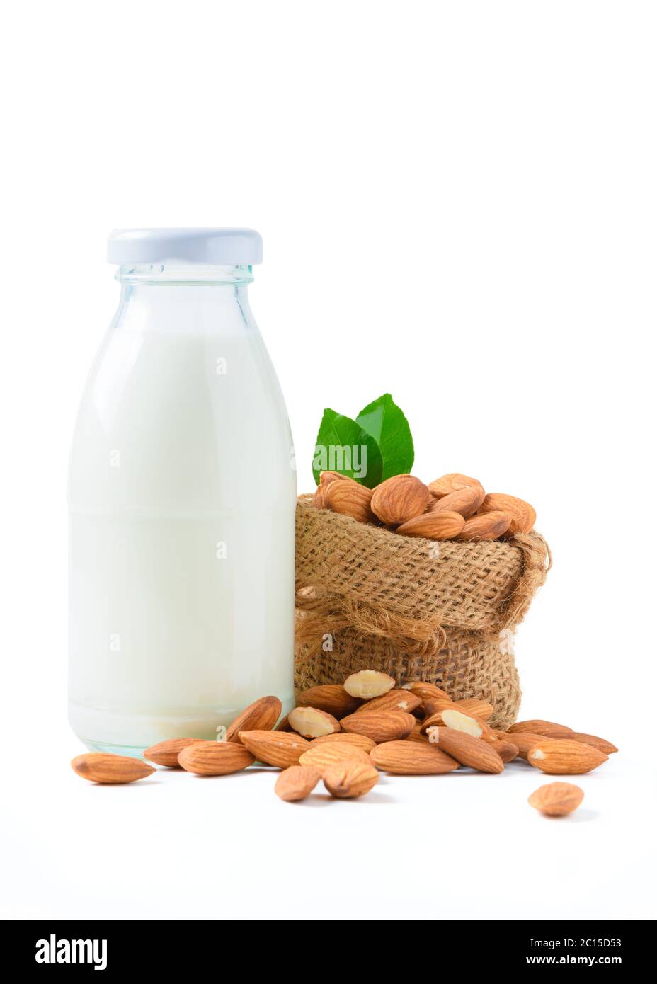 Bouteille de lait et d'amandes noix avec feuille isolée sur fond blanc, les amandes sont des noix très populaires. Les amandes sont riches en gras monoinsaturés sains Banque D'Images