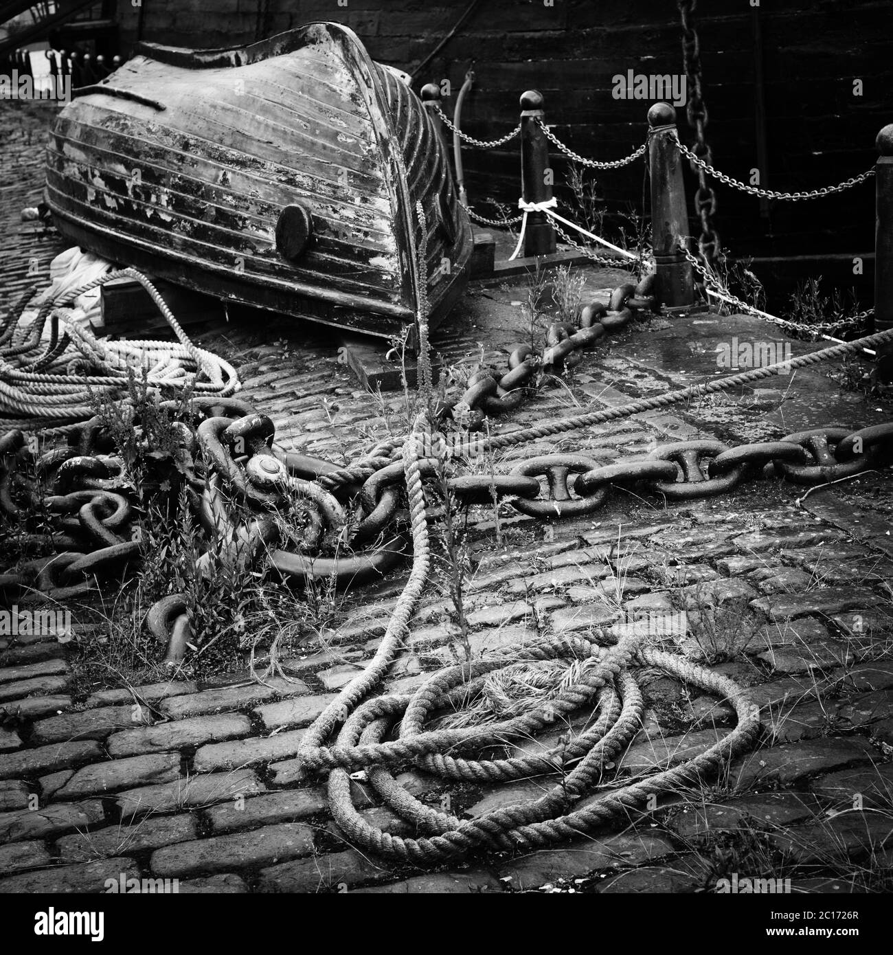 Image monochrome (noir et blanc) de petit bateau et de corde à l'arrêt sur Victoria Dock, Dundee, Écosse, Royaume-Uni. Banque D'Images