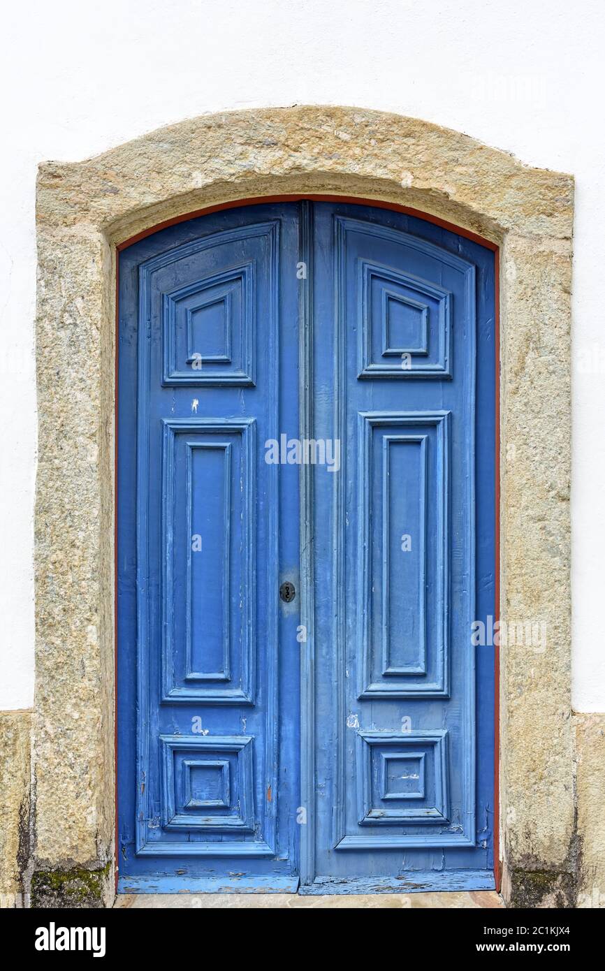 Ancienne porte d'église en bois bleu avec cadre en pierre Banque D'Images