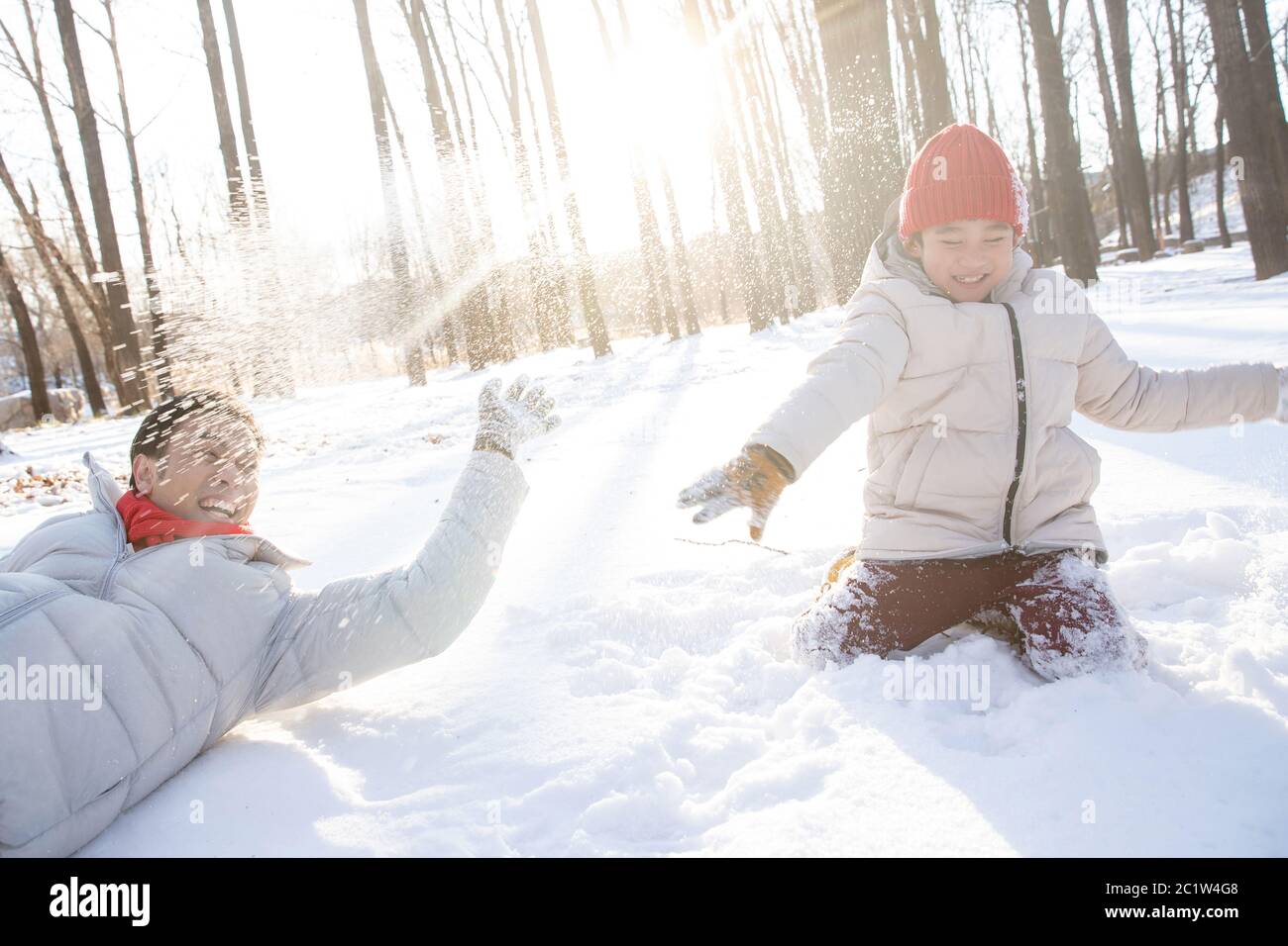Un père et un fils heureux jouent dans la neige Banque D'Images