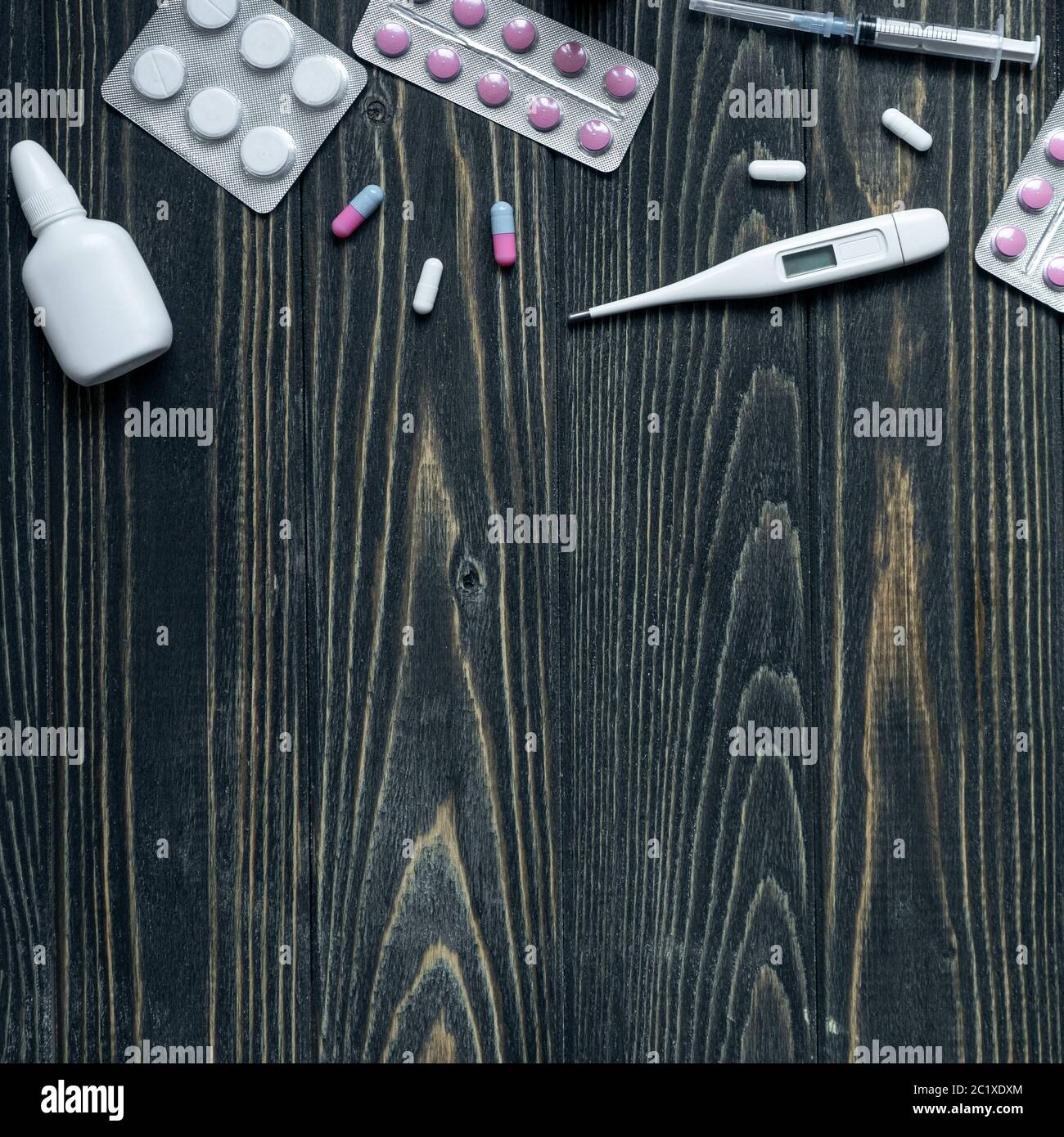 vue de dessus du thermomètre, des pilules et du vaporisateur nasal sur fond de bois Banque D'Images