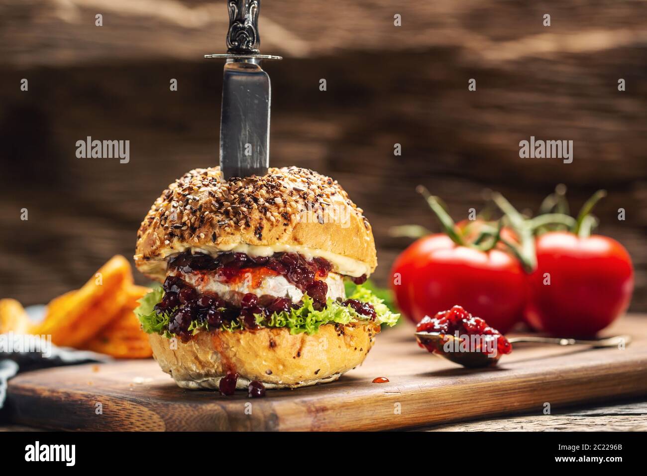 Hamburger végétarien avec sauce camembert et canneberge sur un bois rustique Banque D'Images