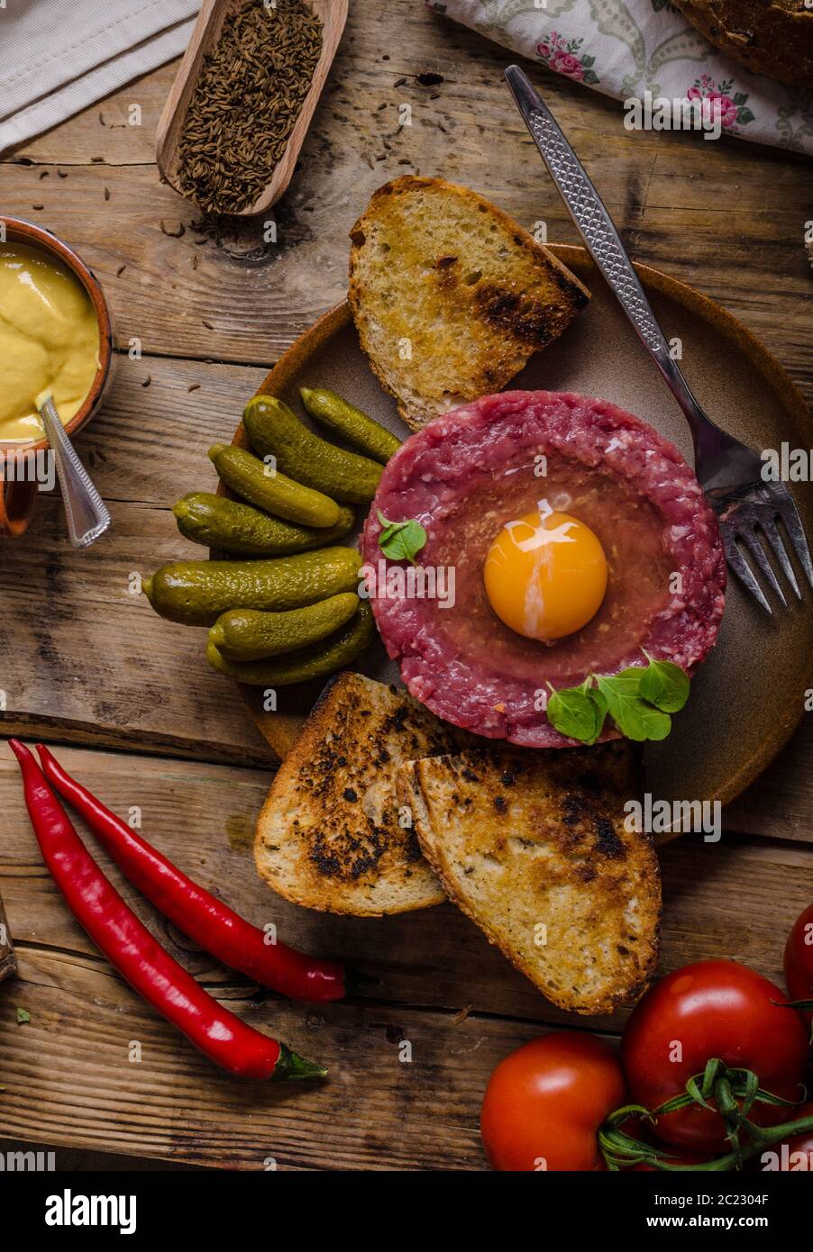 Tartare de boeuf, un plat délicieux plat de protéines avec des épices, de la moutarde, l'oeuf et le pain frit à l'ail Banque D'Images