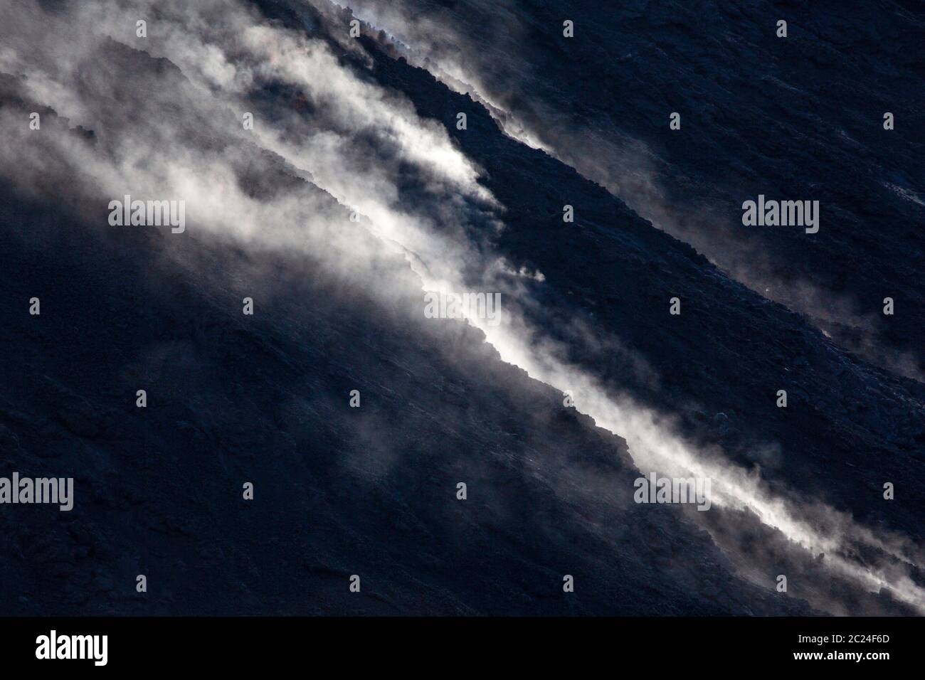 De la fumée s'élève sur le précipice noir du volcan Stromboli Banque D'Images