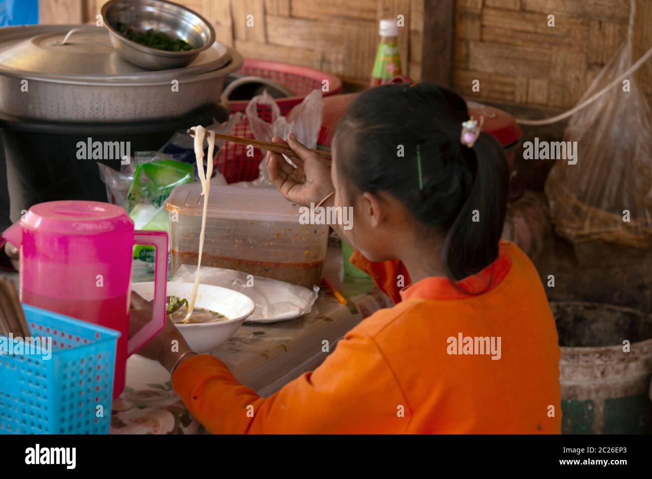 Une femme autochtone de Khmu qui mange de la soupe de nouilles dans son village de la province de Luang Namtha, dans le nord du Laos. Banque D'Images