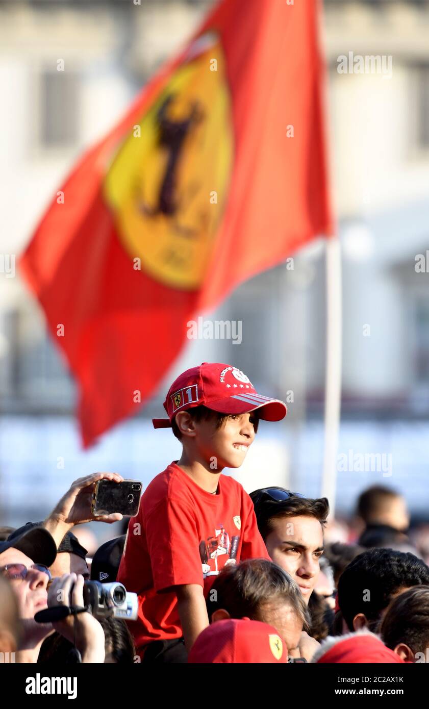 Jeune fan de Ferrari avec drapeau rouge de Ferrari sur la place du Duomo pour célébrer le 90e anniversaire de la Ferrari , à Milan. Banque D'Images
