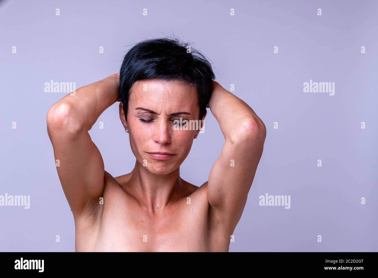 L'accent sur l'anxiété femme avec une céphalée de tension de la défoncer les yeux de douleur et en maintenant ses mains à ses tempes plus de Gray Banque D'Images