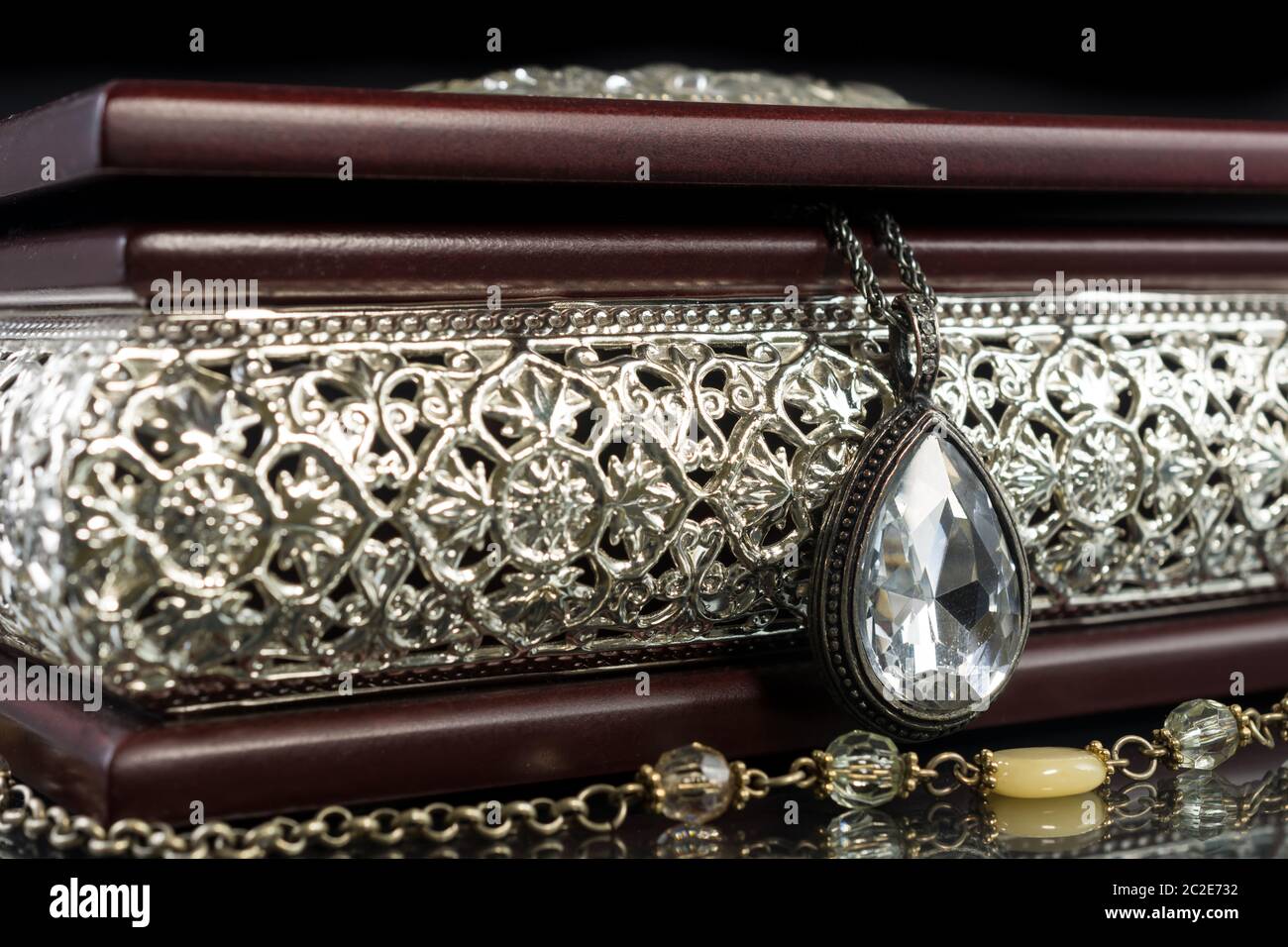 Suspension ovale vintage avec pierre brillante et boîte à bijoux en bois avec éléments décoratifs floraux Banque D'Images