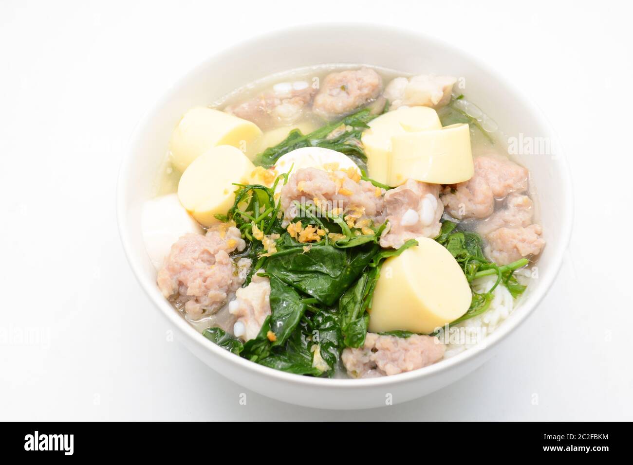 Riz bouilli avec du porc, des feuilles de gourd ivy et du tofu doux Banque D'Images