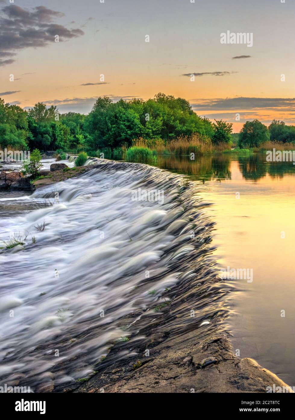 Belle vue sur le barrage sur la rivière Bug du Sud au coucher du soleil. Village d'Migiya, l'Ukraine, le long d'une soirée d'été Banque D'Images