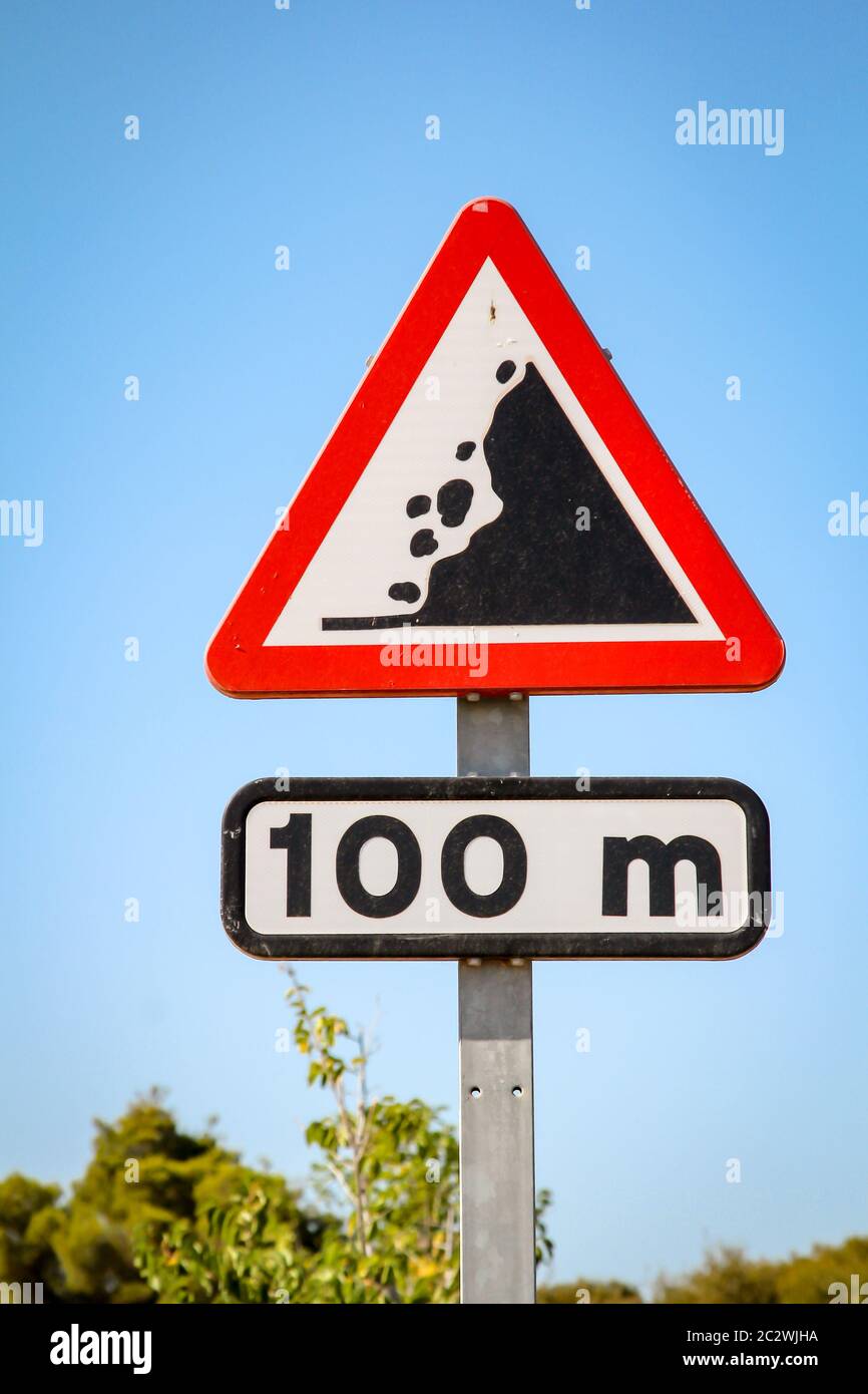 un panneau de signalisation sur la route, une roche lâche, un cri d'attention Banque D'Images