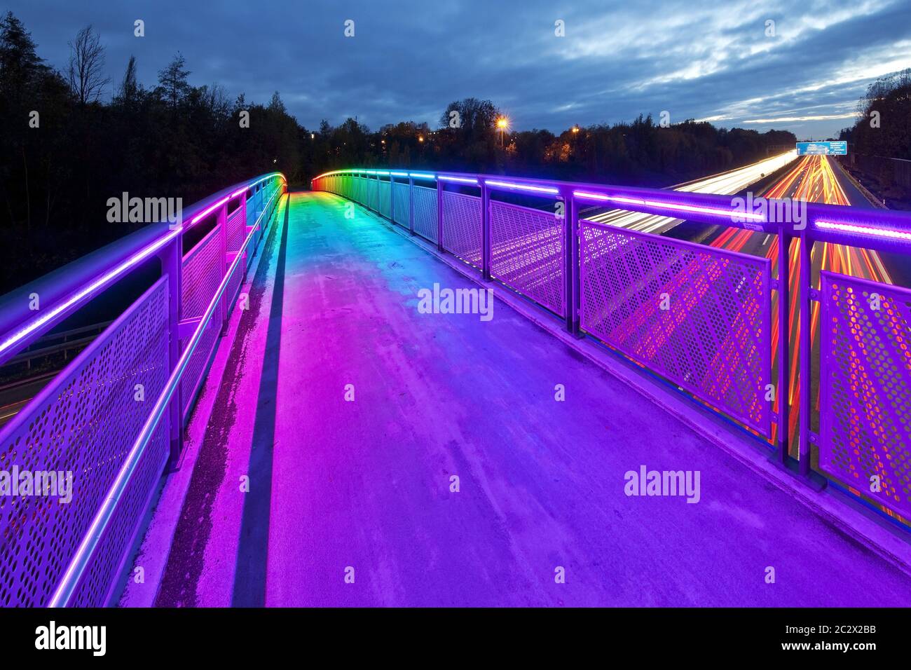 Bride arc-en-ciel illuminé au-dessus de l'autoroute A40 au crépuscule, Dortmund, région de Ruhr, Allemagne, Europe Banque D'Images