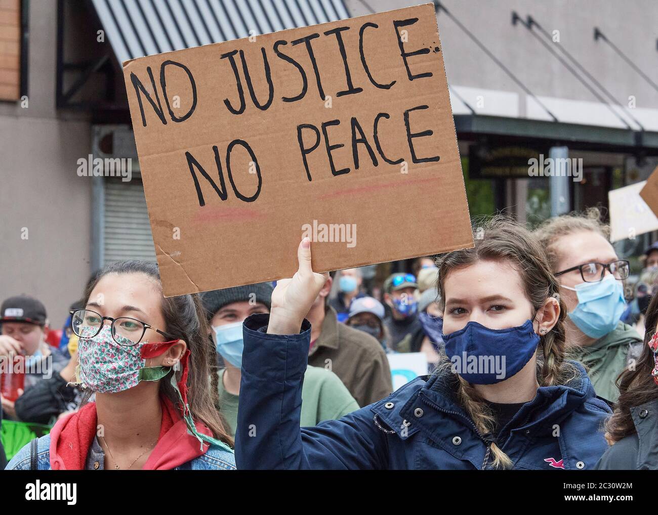 Beaucoup portant des signes, les gens marchent le long d'une rue pendant une manifestation de Black Lives Matter à Eugene, Oregon, le 7 juin 2020. Banque D'Images