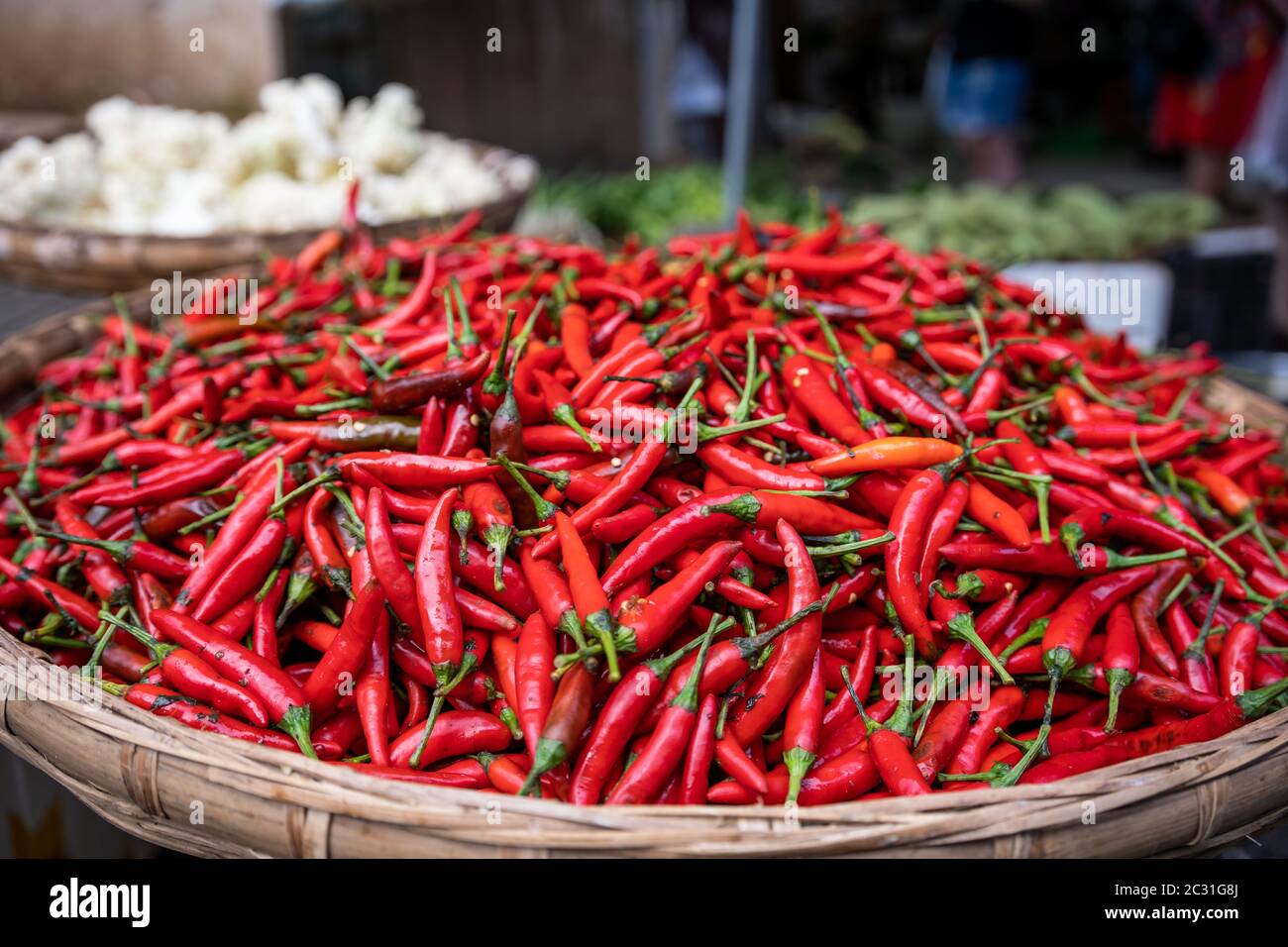 Red Chilis en solde un bol en osier Banque D'Images