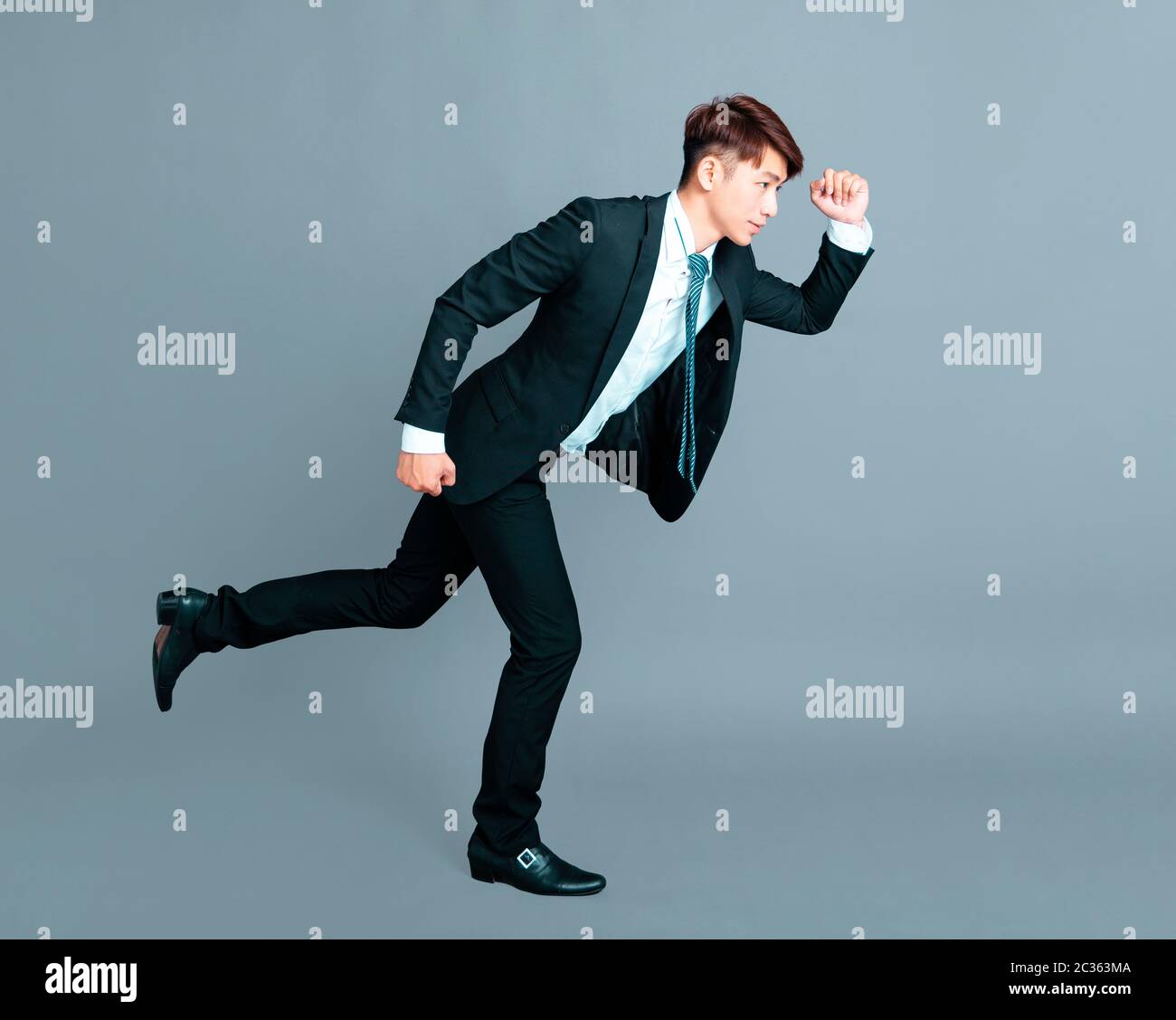 Happy young business man in motion Banque D'Images