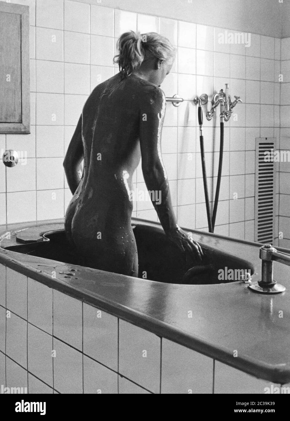 Une femme sort d'un bain de boue. La photo a été prise à Westerland sur Sylt. Photographie non datée, env. 190s. Banque D'Images