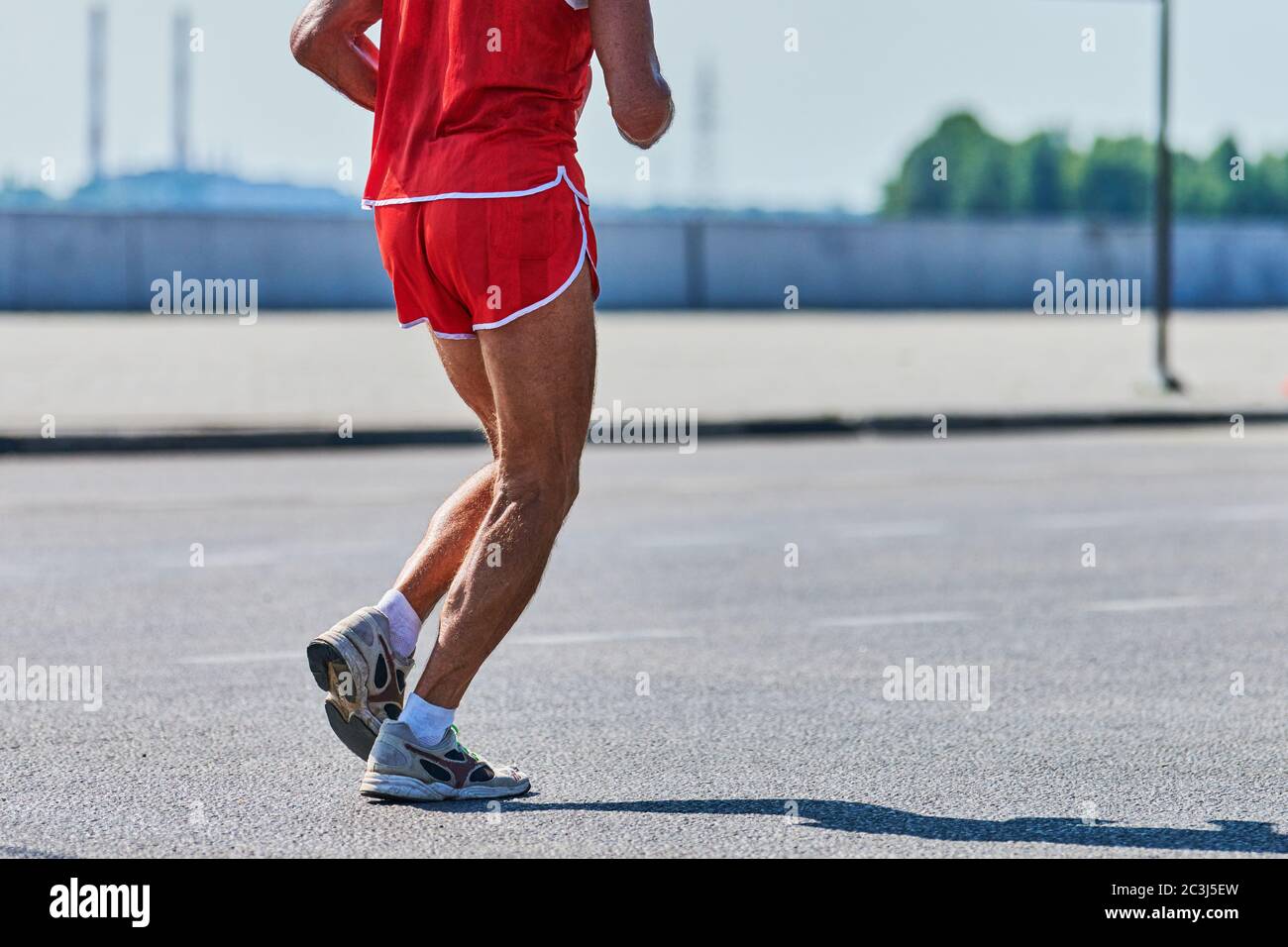 Courir vieux. Un vieil homme qui fait du jogging dans des vêtements de  sport sur la route de la ville. Mode de vie sain, sport de fitness  passe-temps. Entraînement de rue, sprinting